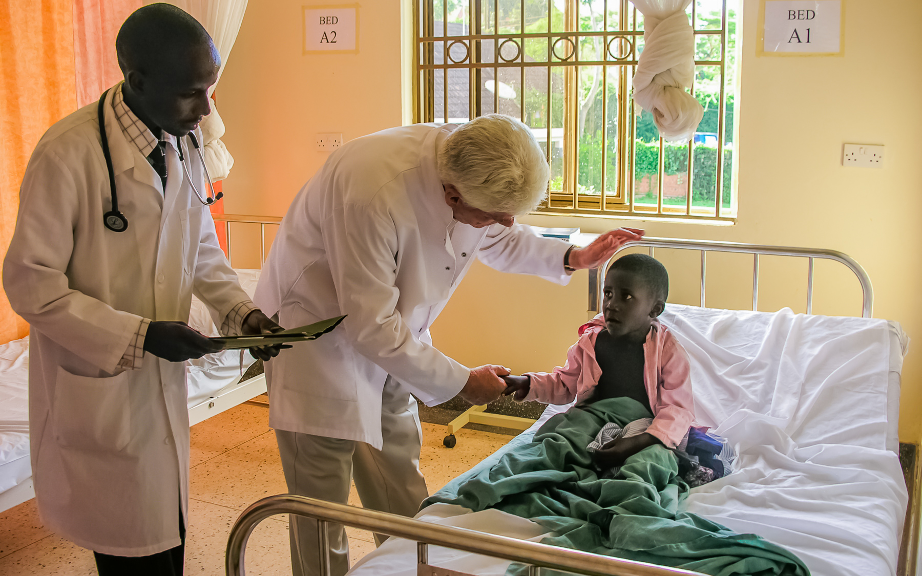 Dr. Wentz visiting children at the Wentz Medical Center in Uganda