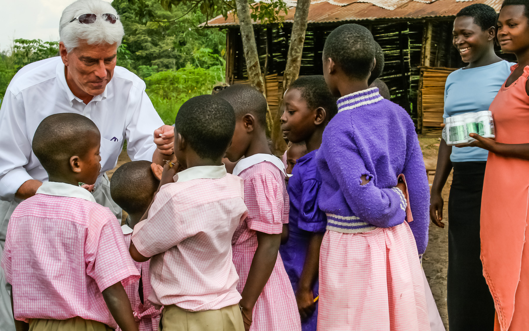 Dr. Wentz giving USANA's children's vitamins, Usanimals™, to children in Uganda