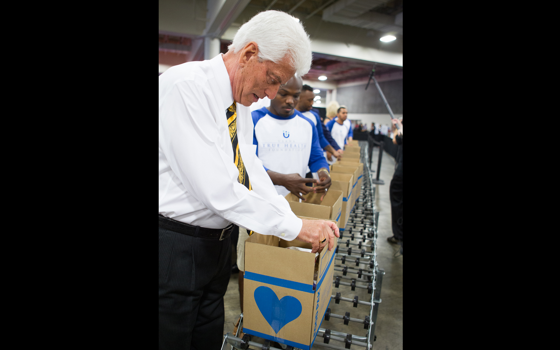 Dr. Wentz packing Children's Hunger Fund boxes with Timothy Bradley at USANA's 2015 International Convention